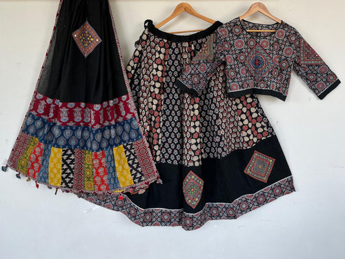 Black cotton chaniya choli with ajrakh patchwork hem band, matching choli and patchwork dupatta with tassels